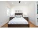 Well-lit bedroom featuring a double bed and wood flooring at 2420 Floyd St, Sarasota, FL 34239