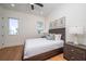 Bright bedroom with a queen bed, wood floors, and large window at 2420 Floyd St, Sarasota, FL 34239