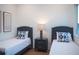 Bedroom with twin beds, nightstand, and wood floors at 2420 Floyd St, Sarasota, FL 34239