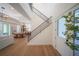 Modern entryway with hardwood floors, staircase with metal railing, and white front door at 2420 Floyd St, Sarasota, FL 34239