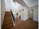 Light and airy entryway with hardwood floors and a modern staircase leading upstairs at 2420 Floyd St, Sarasota, FL 34239