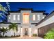 Stunning two-story home with a modern design, featuring a dark-gray roof and a white facade at 2420 Floyd St, Sarasota, FL 34239
