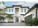 Modern two-story home with white facade, dark gray roof, and a welcoming front entrance at 2420 Floyd St, Sarasota, FL 34239