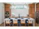 Modern kitchen with a large island, white countertops, and wood cabinets at 2420 Floyd St, Sarasota, FL 34239