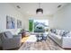 Living room with light gray sofas, a coffee table, and access to a balcony at 2420 Floyd St, Sarasota, FL 34239