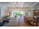 Open concept living space with hardwood floors, a large sectional sofa and a dining area at 2420 Floyd St, Sarasota, FL 34239