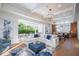 Bright living room with open floor plan, large sectional sofa, and access to backyard patio at 2420 Floyd St, Sarasota, FL 34239