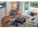 Open living area with L-shaped sectional sofa, wood floors, and stylish decor at 2420 Floyd St, Sarasota, FL 34239