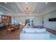 Open living room with white sectional sofa and access to kitchen at 2420 Floyd St, Sarasota, FL 34239