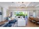 Open concept living room and dining area with hardwood floors and sliding glass doors to backyard at 2420 Floyd St, Sarasota, FL 34239