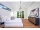Spacious main bedroom with wood floors, large windows, and a dresser at 2420 Floyd St, Sarasota, FL 34239