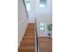 Stylish staircase with light wood steps, dark railing, and high ceilings at 2420 Floyd St, Sarasota, FL 34239