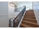 Elegant staircase with black metal railings and light wood steps at 2420 Floyd St, Sarasota, FL 34239