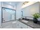Modern bathroom with soaking tub, gray countertops, and frameless glass shower at 2440 Floyd St, Sarasota, FL 34239