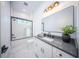 Modern bathroom with white vanity, gray countertop, and walk-in shower at 2440 Floyd St, Sarasota, FL 34239
