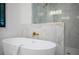 Modern bathroom featuring a freestanding bathtub and marble tile at 2440 Floyd St, Sarasota, FL 34239