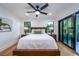 Spacious bedroom with wood floors and sliding doors to a private balcony at 2440 Floyd St, Sarasota, FL 34239