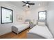 Two twin beds in a bright bedroom with hardwood floors and large windows at 2440 Floyd St, Sarasota, FL 34239