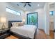 Bedroom with private balcony, wood floors, and stylish decor at 2440 Floyd St, Sarasota, FL 34239