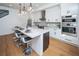 Modern kitchen with island, stainless steel appliances, and hardwood floors at 2440 Floyd St, Sarasota, FL 34239