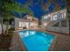 Stunning pool and backyard at dusk with modern home in background at 2440 Floyd St, Sarasota, FL 34239
