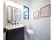 Modern powder room with dark vanity and patterned tile floor at 2440 Floyd St, Sarasota, FL 34239