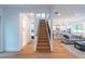 Modern staircase with wooden steps and metal railing, leading to upper level at 2440 Floyd St, Sarasota, FL 34239