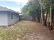 Large backyard with mature trees and wood fence at 2825 Sequoia Ln, Sarasota, FL 34237