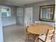 Dining area with wood table and chairs near a door at 2825 Sequoia Ln, Sarasota, FL 34237