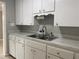 White kitchen with double sink and cabinets at 2825 Sequoia Ln, Sarasota, FL 34237