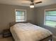 Relaxing main bedroom with a ceiling fan and large windows at 2825 Sequoia Ln, Sarasota, FL 34237