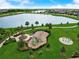 Aerial view of a community park with playground, lake, and walking paths at 5415 Limelight Dr, Apollo Beach, FL 33572