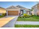 Two-story home with a two-car garage and lush landscaping at 5415 Limelight Dr, Apollo Beach, FL 33572