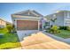 Two-story home with a brown garage door and landscaping at 5415 Limelight Dr, Apollo Beach, FL 33572