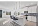 Bright kitchen featuring an island, white cabinets, and stylish backsplash at 5415 Limelight Dr, Apollo Beach, FL 33572