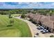 Aerial view of community clubhouse, golf course, and cart storage at 7607 Grand Estuary Trl # 205, Bradenton, FL 34212