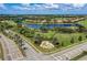 Aerial view of a luxury community with a golf course, lake, and upscale homes at 7607 Grand Estuary Trl # 205, Bradenton, FL 34212