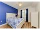 Bright bedroom with white furniture and blue accent wall at 7607 Grand Estuary Trl # 205, Bradenton, FL 34212