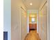 Hallway with light wood flooring and access to bathroom at 7607 Grand Estuary Trl # 205, Bradenton, FL 34212