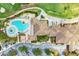 Aerial view of community pool, clubhouse and surrounding landscape at 7607 Grand Estuary Trl # 205, Bradenton, FL 34212