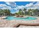 Circular pool with surrounding lounge chairs and landscaping at 7607 Grand Estuary Trl # 205, Bradenton, FL 34212