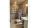 Bathroom with shower/tub combo, pedestal sink, and tiled floors at 3375 8Th St, Sarasota, FL 34237