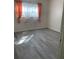 Bright bedroom with gray wood-look floors and pink curtains at 3375 8Th St, Sarasota, FL 34237
