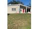 Tan single story home with red door and grassy yard at 3375 8Th St, Sarasota, FL 34237