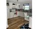 Kitchen with white cabinets, granite counters, and wood floors at 3375 8Th St, Sarasota, FL 34237