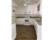White kitchen with granite countertops and wood-look floors at 3375 8Th St, Sarasota, FL 34237