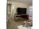 Living room with TV, small table and access to balcony at 3375 8Th St, Sarasota, FL 34237