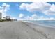 Stunning beachfront view with ocean waves and white sand at 1750 Benjamin Franklin Dr # 2G, Sarasota, FL 34236