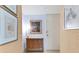 Bright condo entryway with wood cabinet and artwork at 1750 Benjamin Franklin Dr # 2G, Sarasota, FL 34236