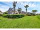 Landscaped backyard with lush greenery and screened enclosure at 5901 Mariposa Ln, Sarasota, FL 34238